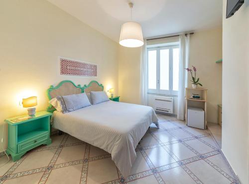 a bedroom with a large bed and a window at B&B Marcantonio - Ischia Ponte in Ischia