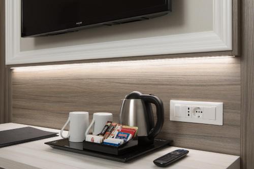 a coffee pot on a tray next to a tv at Hotel San Giusto in Trieste