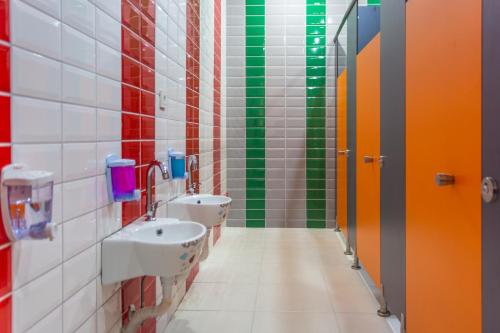 a bathroom with two sinks and colorful walls at Lonicera World - Ultra All Inclusive in Avsallar