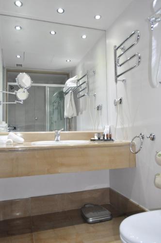 a bathroom with a sink and a mirror at Capsis Bristol Boutique Hotel in Thessaloniki