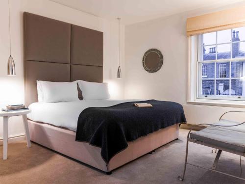 A bed or beds in a room at The Crown Hotel 