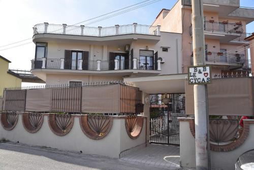 a building with balconies and a street sign on a pole at B&b Le Cycas in Castellammare di Stabia