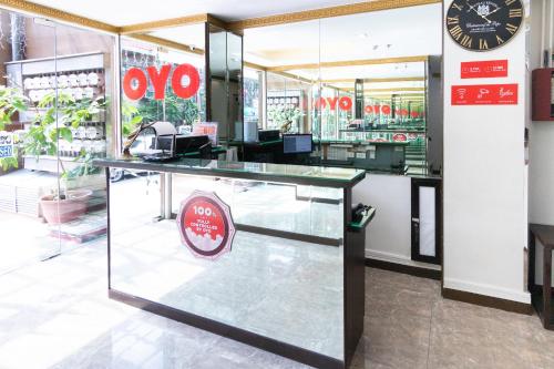 a shop with a counter with a clock on the wall at OYO 152 Sangco Condotel in Manila