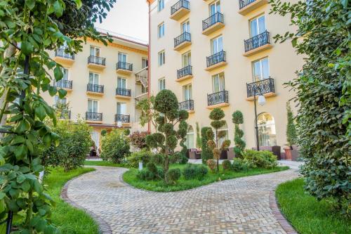 a building with a path in front of it at LOTTE City Hotels Tashkent Palace in Tashkent