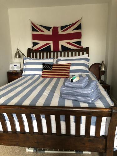 a bed with an american flag and towels on it at waves whitstable in Whitstable