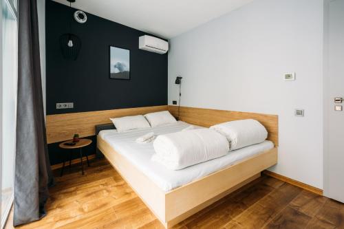 a bed in a room with a wooden floor at Yard Hostel & Coffee in Chernivtsi
