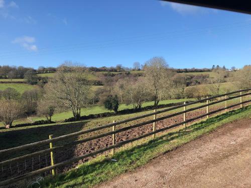 a fence on the side of a road next to a field at Welsh Marches at Upper Glyn Farm in Chepstow
