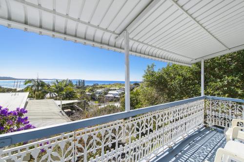a white pergola on a balcony overlooking the ocean at Whitecaps, 26 East Street in Crescent Head