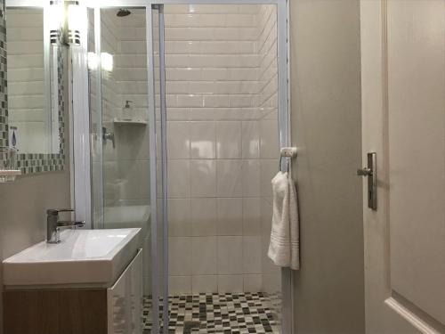a bathroom with a shower and a sink and a toilet at Anathi Hotel in Kokstad