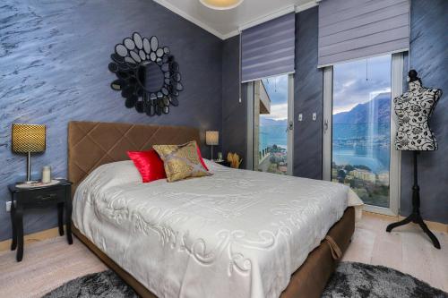 a bedroom with a large bed and a large window at Apartment Per Te in Kotor