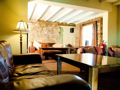 a living room with a couch and a table at Beansheaf Hotel in Pickering