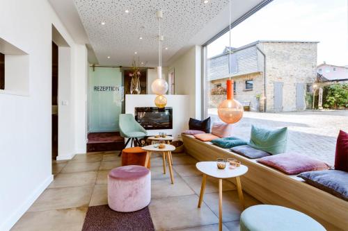 a living room with a couch and tables and a tv at Hotel F-RITZ in Schleswig
