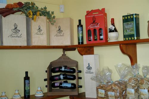 a shelf with bottles of wine and bread on it at Tenuta Annibale in Leverano