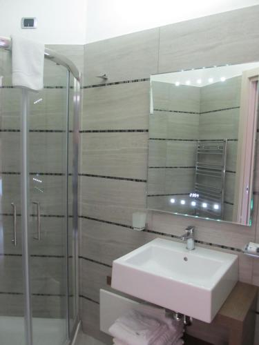 a bathroom with a sink and a mirror at Hotel L'Approdo in Anzio