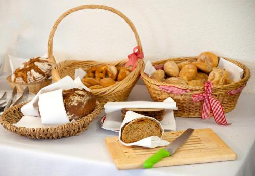 a table with baskets of bread and baskets of bread at Land-gut-Hotel Höhengasthof Adler in Lauterbach