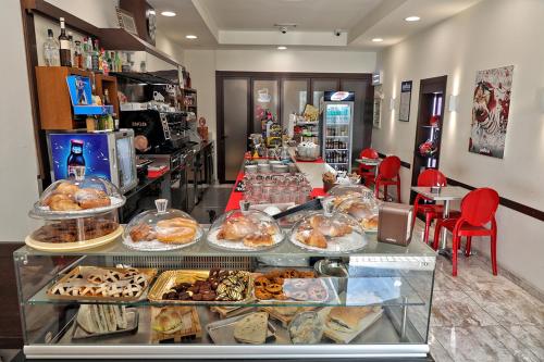a bakery with a display case filled with lots of pastries at Hotel Al Castello in Pomezia
