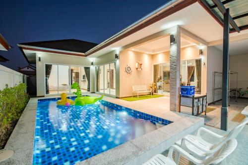 a swimming pool in the backyard of a house at Greenview Pool Villa Cha-am in Cha Am