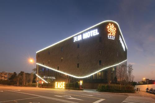 a building with lights on the side of it at Ease Motel Taichung in Taichung