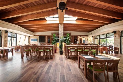 a dining room with wooden tables and chairs at Villas and apartments Oaza in Sarajevo