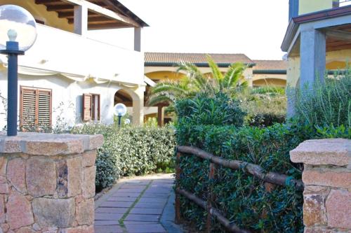 a fence in front of a house with a street light at Casa THE NEST - Il Nido sul Mare in Badesi