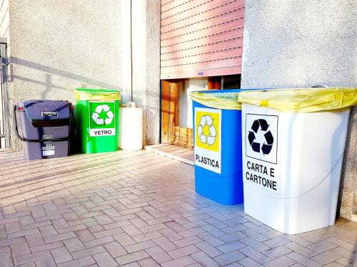 a group of trash cans sitting outside of a building at Guest House Vecchi in Reggio Emilia