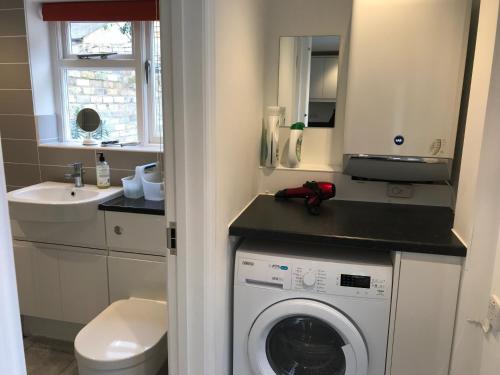 Un pequeño baño con lavadora y lavabo. en 200m To Botanical Garden 3 Bedroom Victoria House, en Cambridge