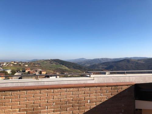 a brick wall with a view of the mountains at Hotel Lo Zodiaco in Oppido Lucano