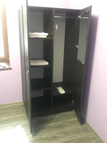 a black cabinet with towels in a bathroom at Hotel Victoria in Yerevan