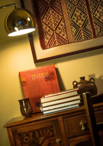 a pile of books sitting on top of a table at BE Jardin Escondido By Coppola in Buenos Aires