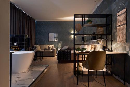 - un salon avec une baignoire et un canapé dans l'établissement Hotel Zuid, à Genk