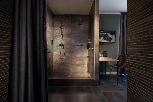 a bathroom with a shower with a glass door at Hotel Zuid in Genk