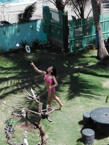 a young girl in a pink bathing suit throwing a frisbee at Toni Arts Villa in Nabas