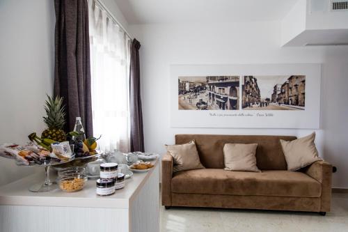a living room with a couch and a table with food at Hotel San Luca in Battipaglia