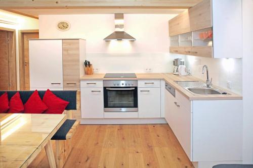 a kitchen with a sink and a stove top oven at Stockklauser in Lofer