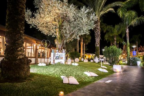a garden at night with white objects on the grass at Hotel San Luca in Battipaglia