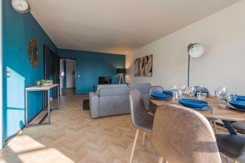 a living room with a dining table and a couch at Cosy flat in Disneyland BMYGUEST in Serris