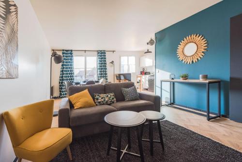 a living room with a couch and a table at Cosy flat in Disneyland BMYGUEST in Serris