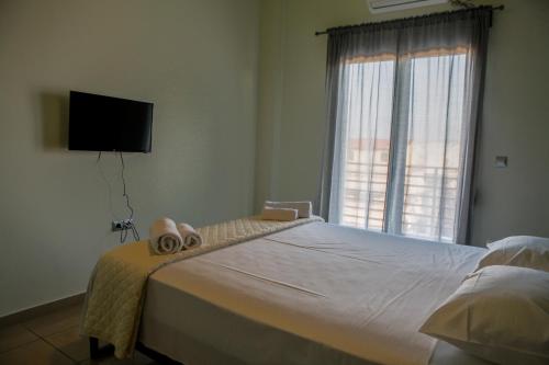 a bedroom with a large bed with towels on it at Lak Peristeri Homes 50m from metro station in Athens