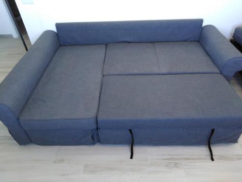 a blue couch sitting in a living room at Lopes Apartment - Belch1952 in Lagos