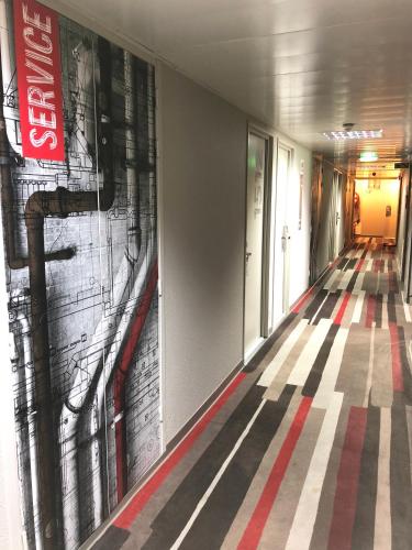 a hallway with a painting on the wall at ibis Paris Porte de Montreuil in Paris