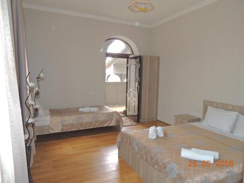 a hotel room with two beds and a window at Old Town Akhaltsikhe in Akhaltsikhe