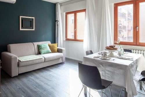 a living room with a table and a couch at Laguna Boutique Apartments in Mestre