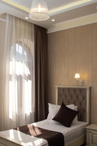 a bedroom with a bed with a large window at Armenia in Nerkʼin Giratʼagh