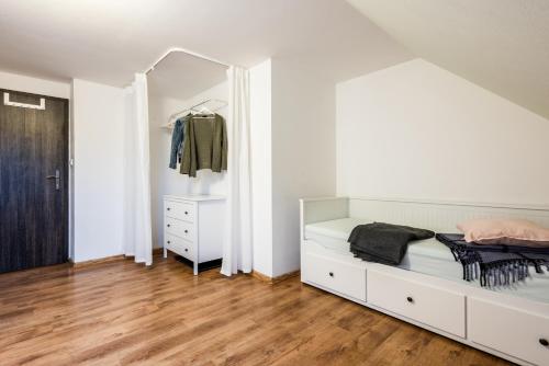 a bedroom with a bed and a mirror at Slavia penzion in Mikulov