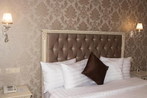 a bedroom with a bed with white pillows at Armenia in Nerkʼin Giratʼagh