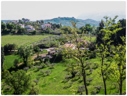 a village in a green field with trees at Tra mare e monti in Chieti
