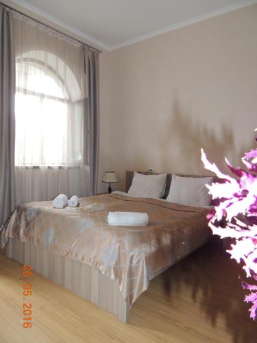 a bedroom with a large bed with a window at Old Town Akhaltsikhe in Akhaltsikhe