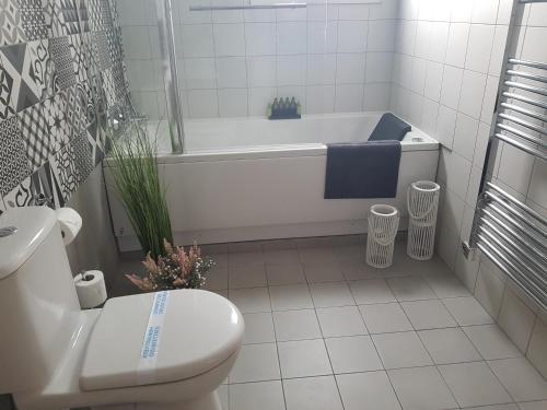 a bathroom with a tub and a toilet and a sink at Evmelia Kakopetria Suites in Kakopetria