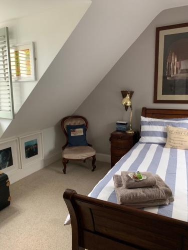 a bedroom with a bed and a chair at waves whitstable in Whitstable
