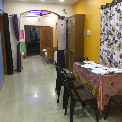 a dining room with a table and some chairs and a table and chairsktop at Jayaram Residency Tirupathi in Tirupati